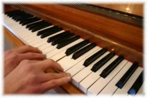 Fingers on the edge of piano notes